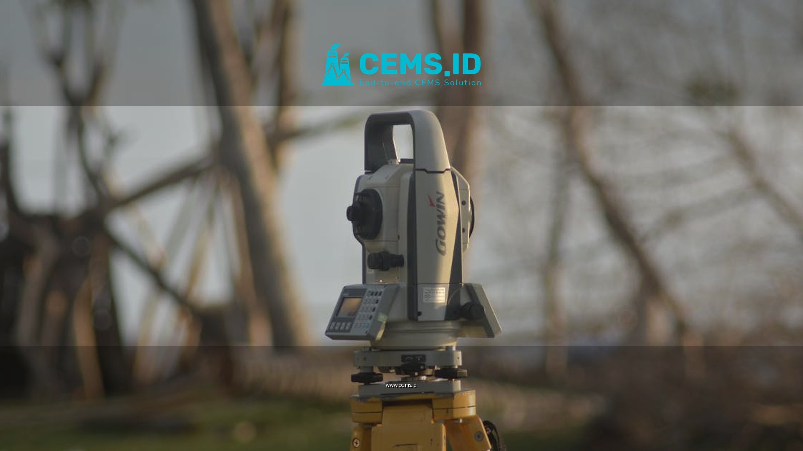 A precise total station used for geodetic surveying at a construction site with a natural background.