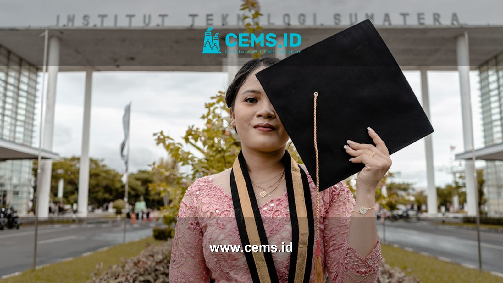 Asian female graduate posing with cap at Institut Teknologi Sumatera.