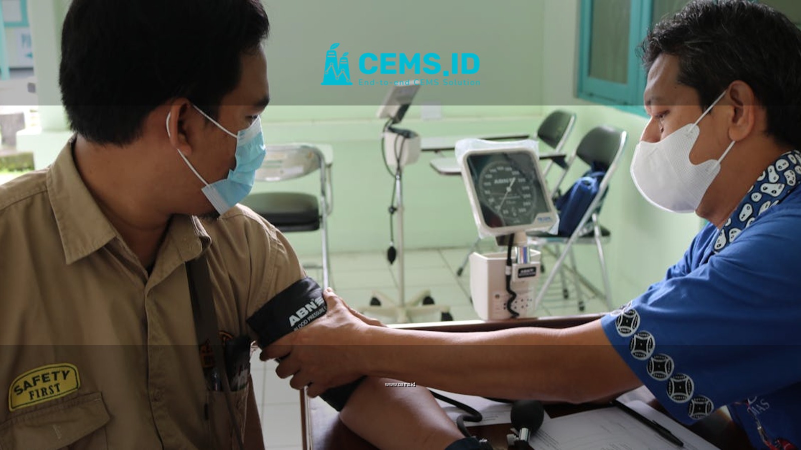 Healthcare professional measuring patient's blood pressure in a medical setting.