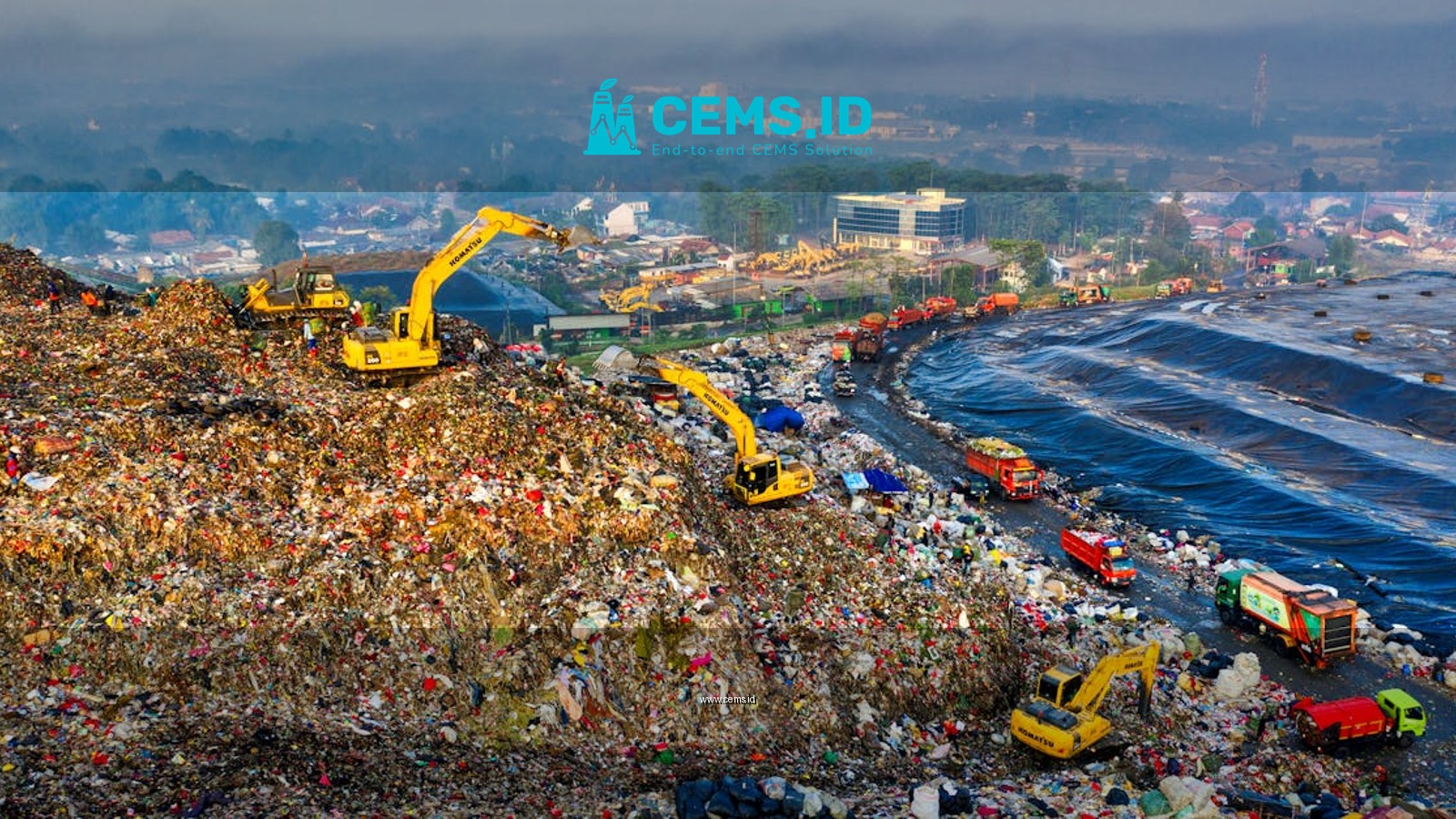 Aerial view showing heavy machinery at a landfill site in West Java, Indonesia.