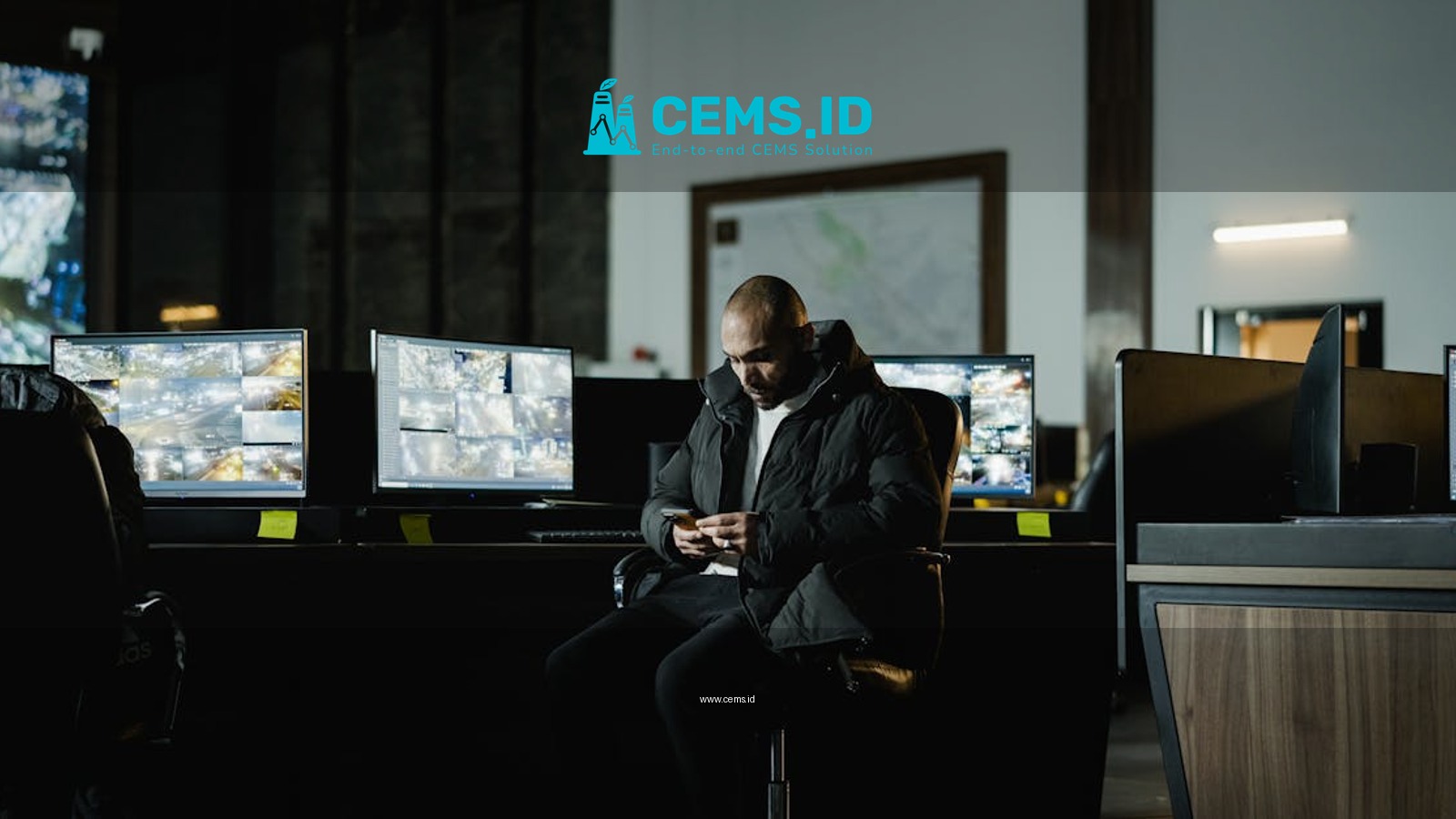 Security officer seated in a dimly lit control room, analyzing multiple surveillance screens.