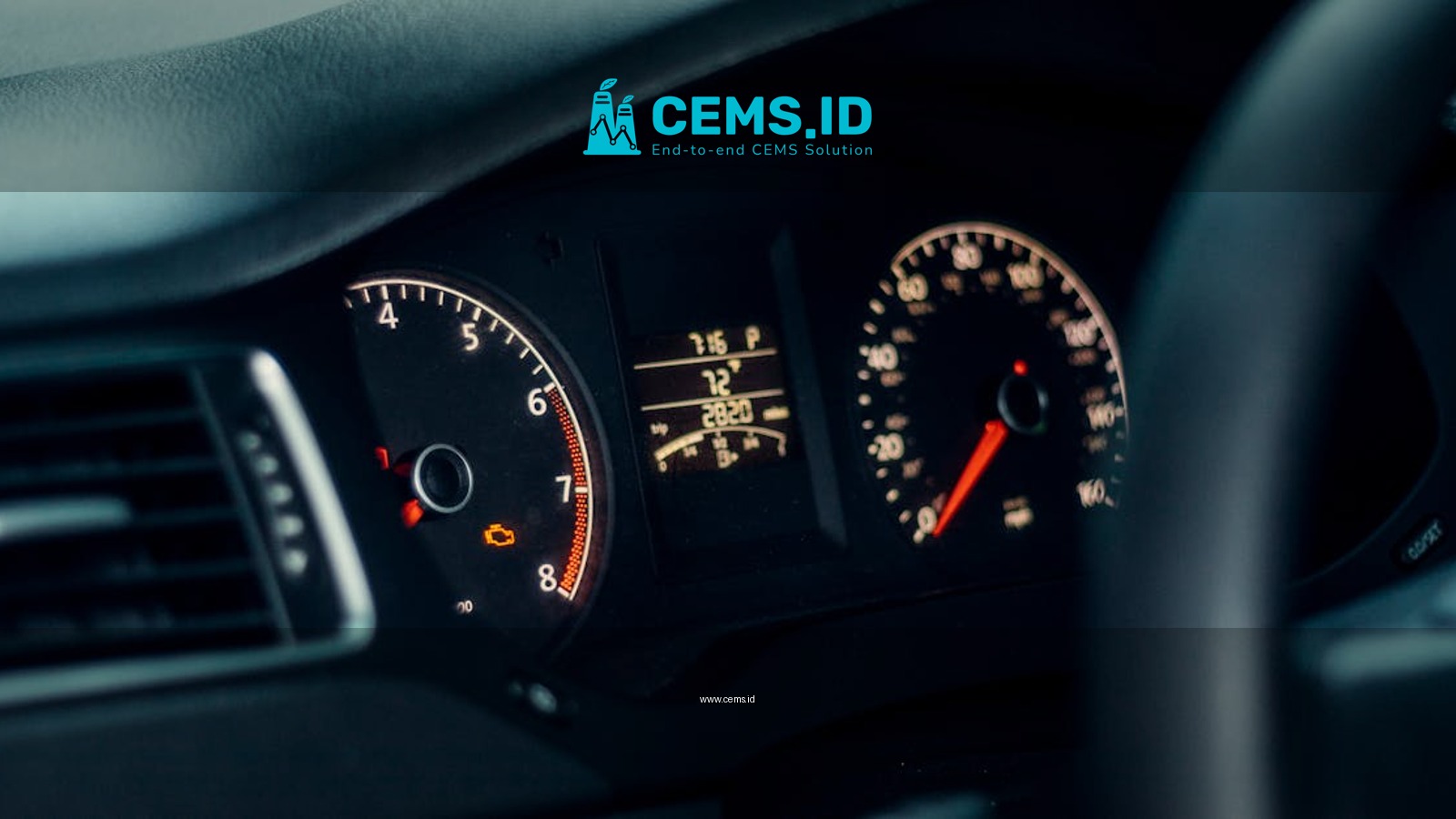 Detailed view of a car's dashboard featuring illuminated gauges and speedometer.