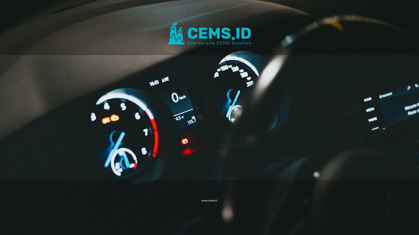 Detailed view of an illuminated car dashboard with speedometer and odometer visible.