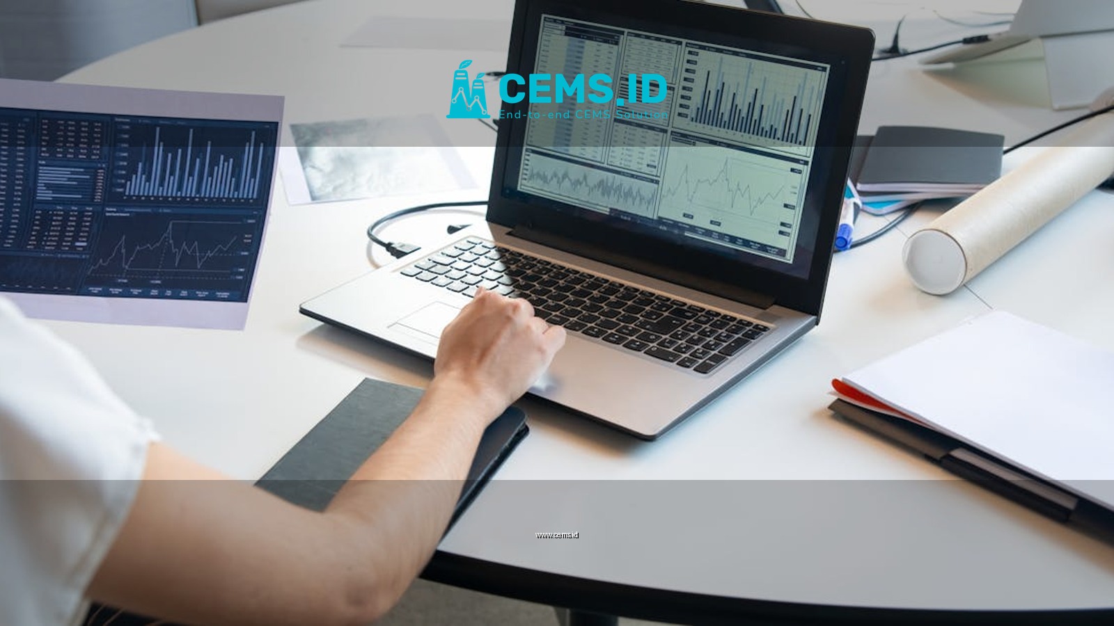 Business person evaluating financial charts on a laptop in a modern office setting.