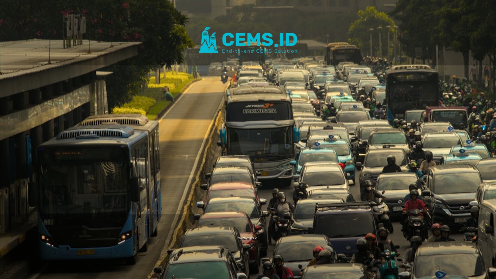 Heavy traffic in a city with cars, buses, and motorcycles on a crowded road.