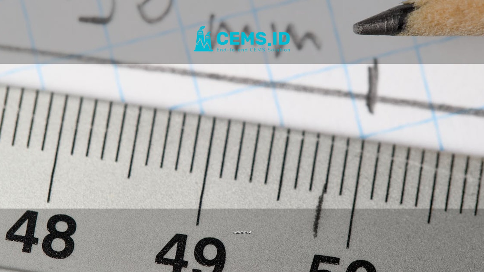 Detailed image of a ruler and pencil marking 50mm on graph paper.