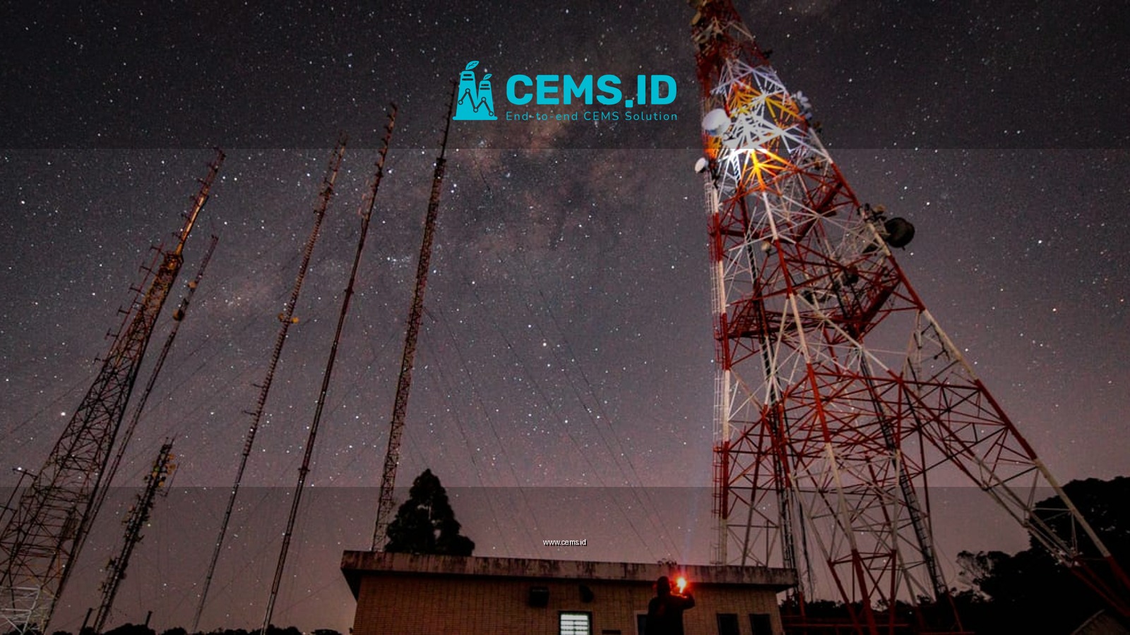 Starry night with radio towers and the Milky Way galaxy visible overhead.
