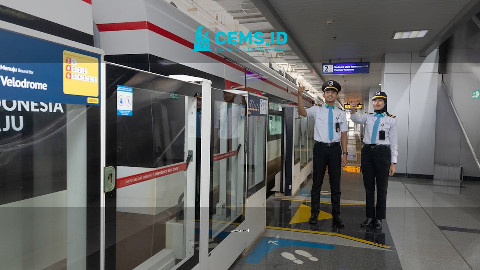 Two uniformed staff stand at a modern train platform, signaling departure readiness.