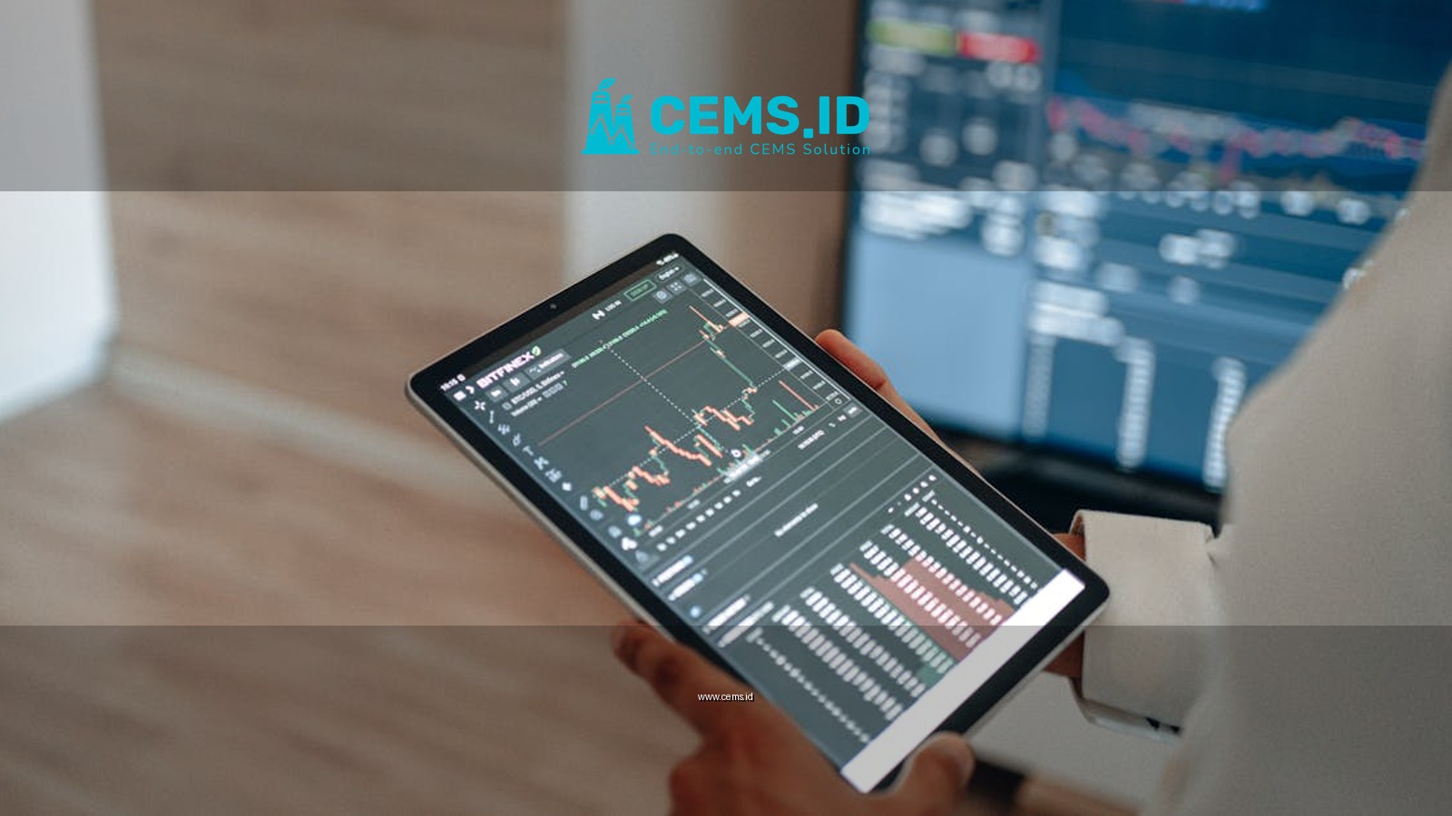 A person uses a tablet to monitor stock market trends and real-time trading graphs.