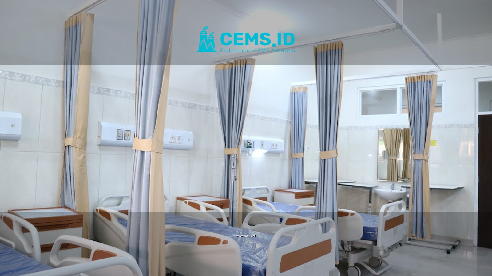 Spacious hospital ward with modern equipment and private patient areas.