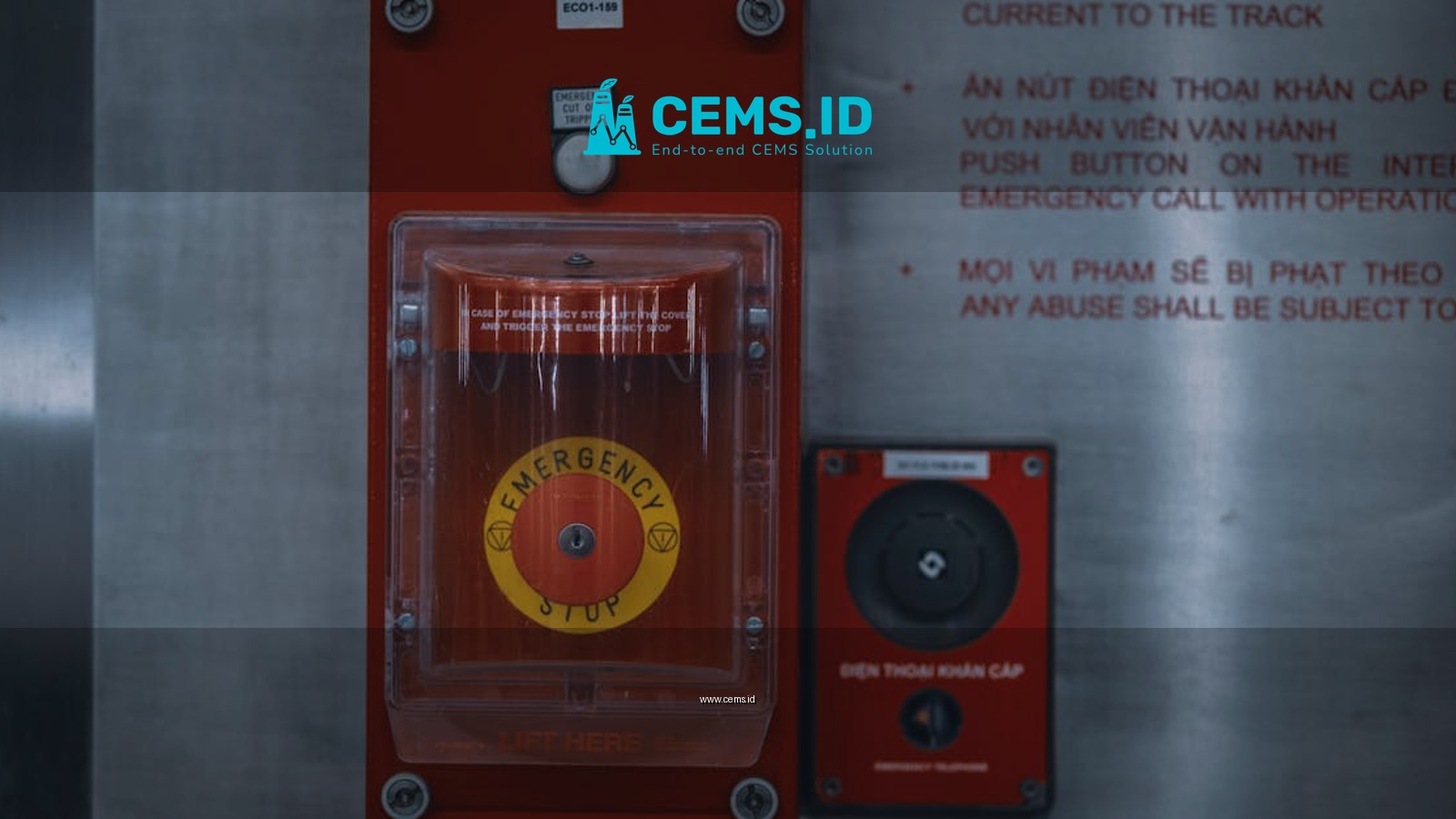 Close-up of an emergency stop button with warning text on an industrial panel.
