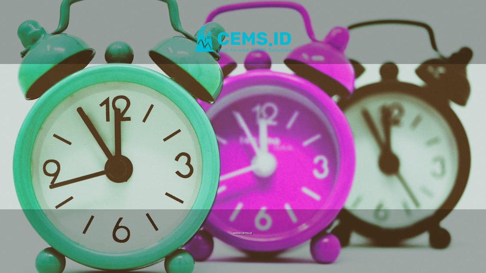 Vibrant set of vintage alarm clocks in teal, pink, and black.
