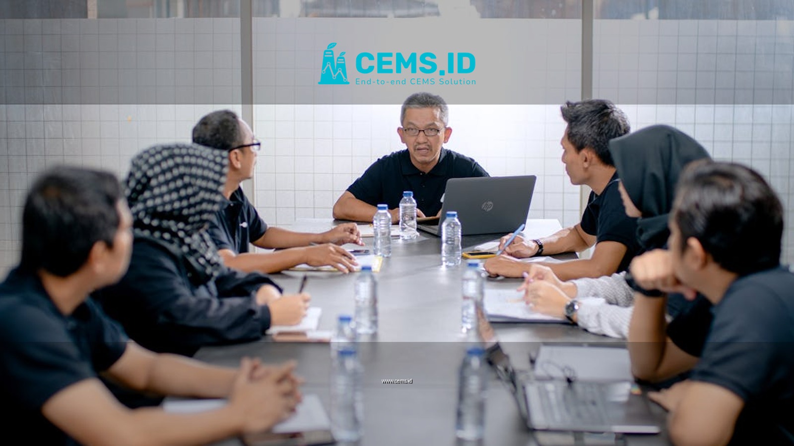 Professional team meeting around a conference table in an office setting.