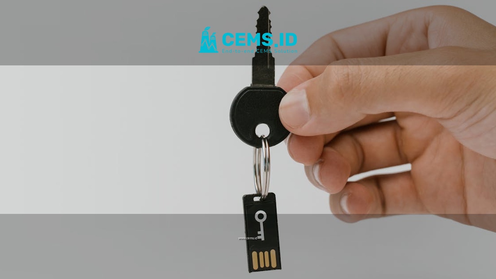 A close-up of a hand holding a key with an attached USB drive, highlighting security and technology.