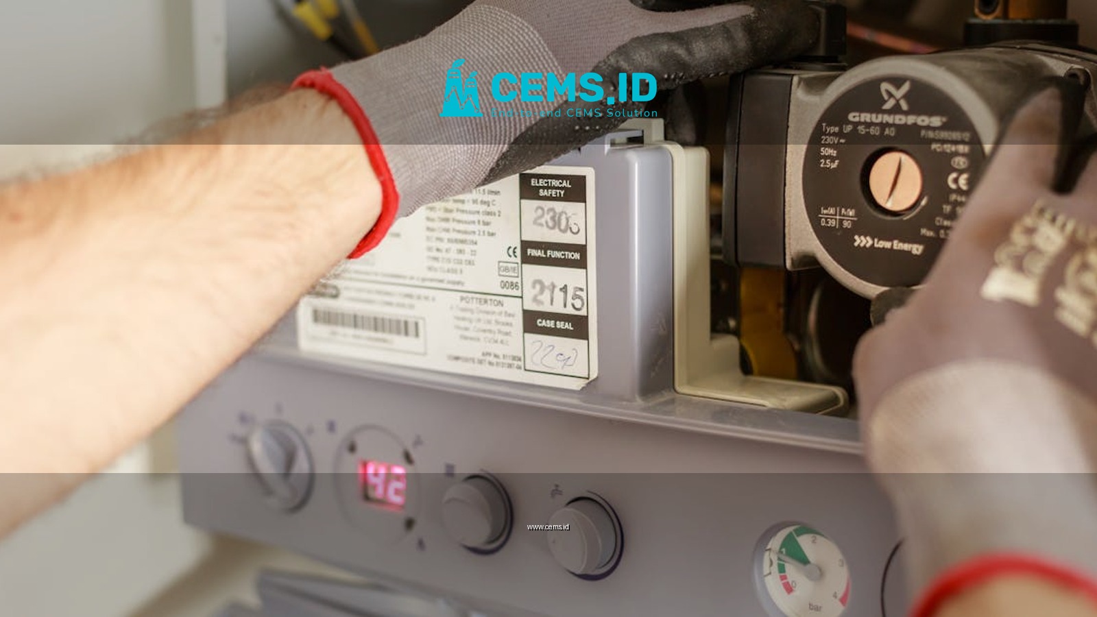 Close-up of hands adjusting a boiler system with precise instrumentation, showing maintenance work.
