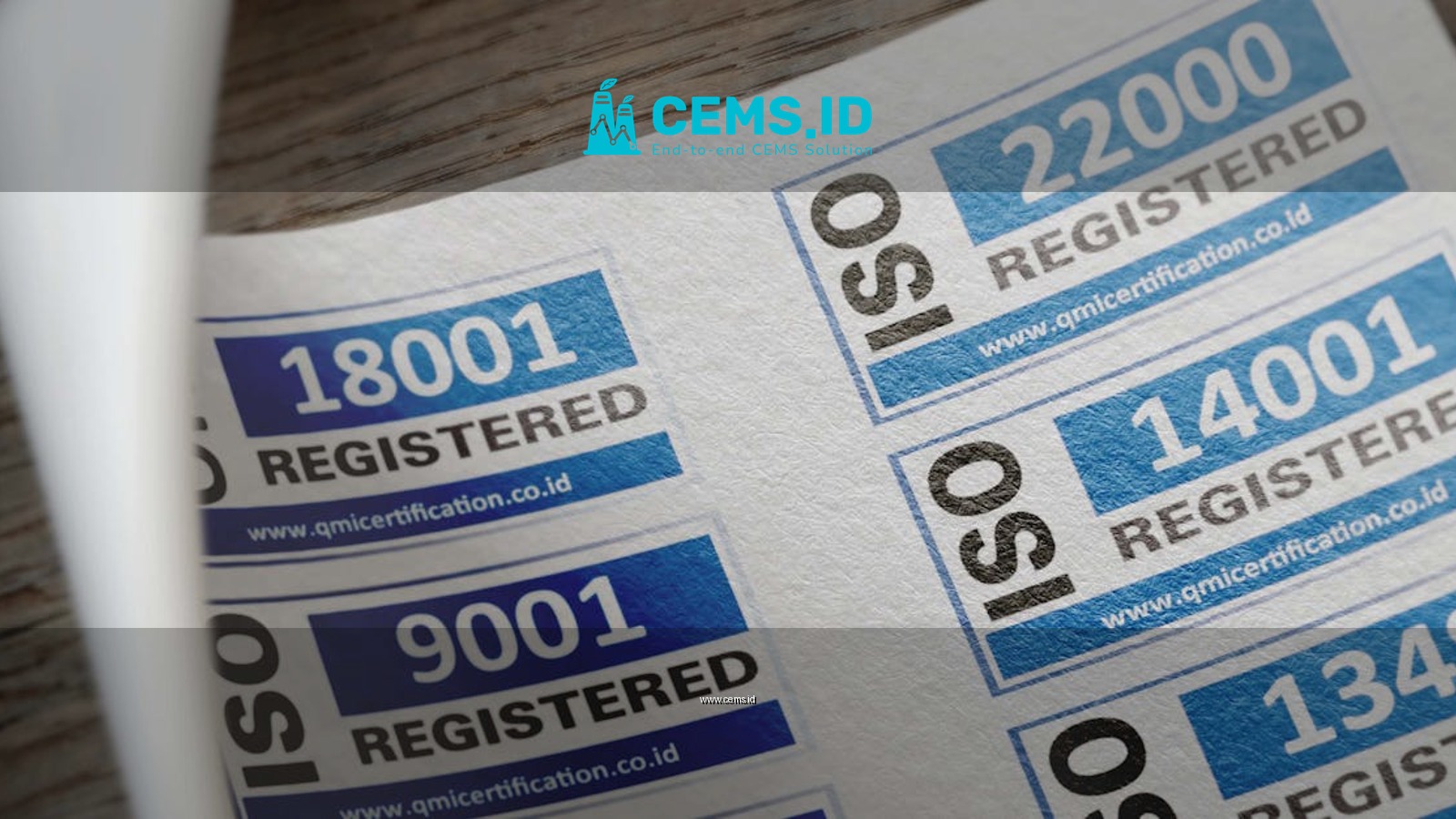 ISO certification stickers with registration numbers on paper.