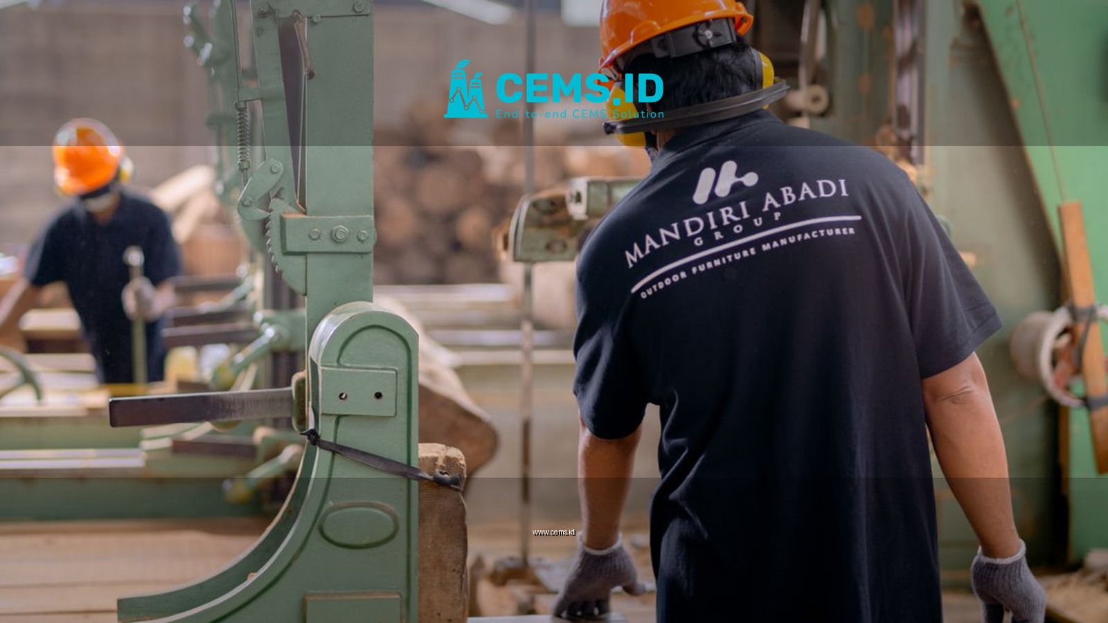 Workers wearing protective gear operating machinery in a factory environment, focusing on safety and production.