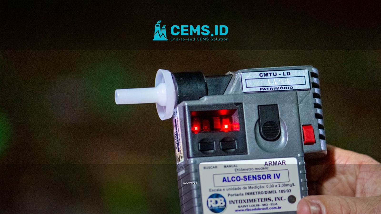 Detailed close-up of Alco-Sensor IV breathalyzer device held by a person outdoors in Londrina, Brazil.