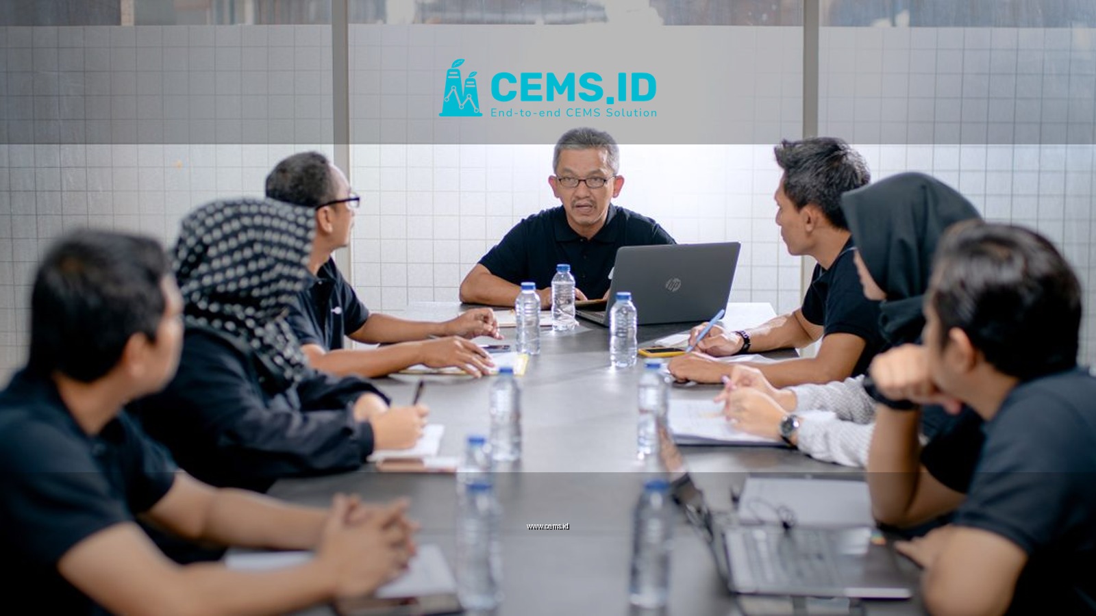 Professional team meeting around a conference table in an office setting.