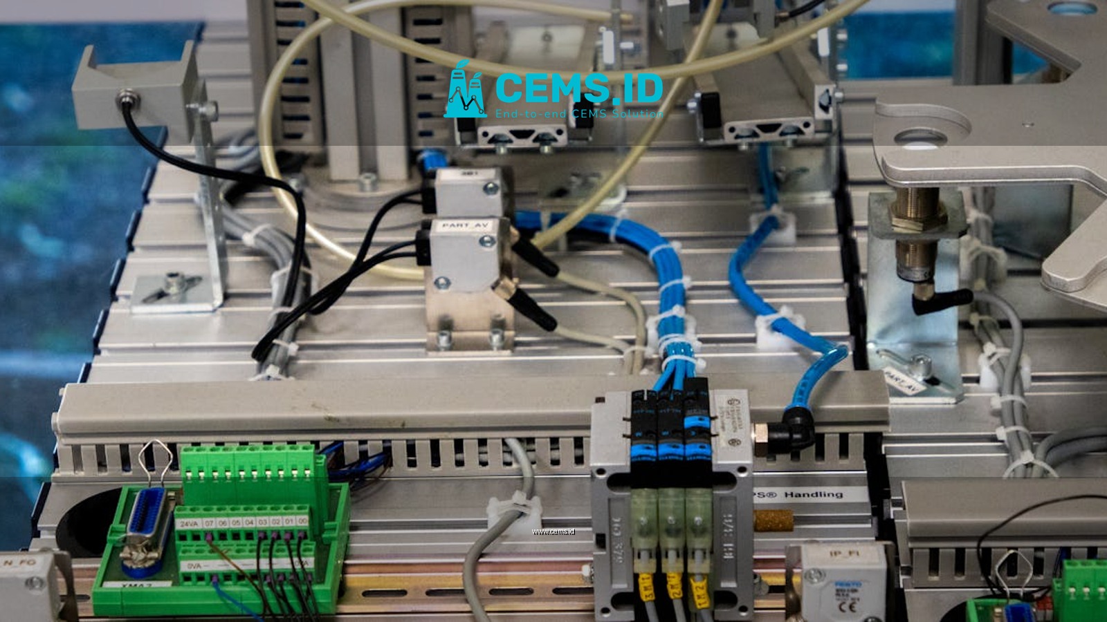 Close-up of industrial equipment showcasing electronic wiring and sensors in a manufacturing setup.