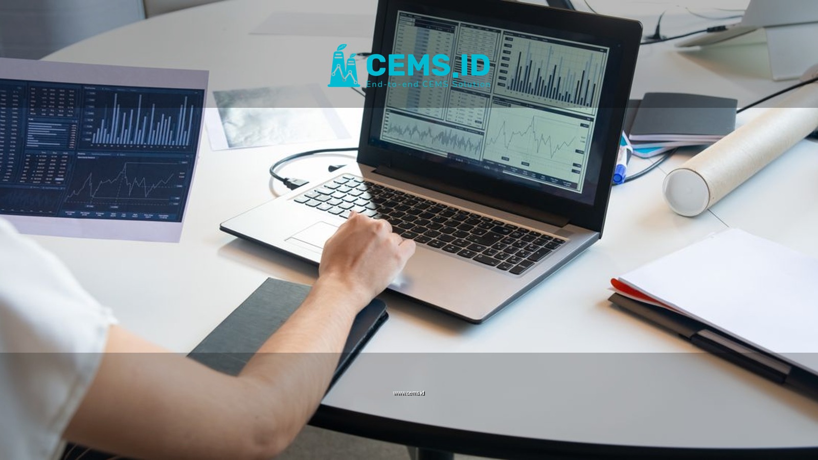 Business person evaluating financial charts on a laptop in a modern office setting.