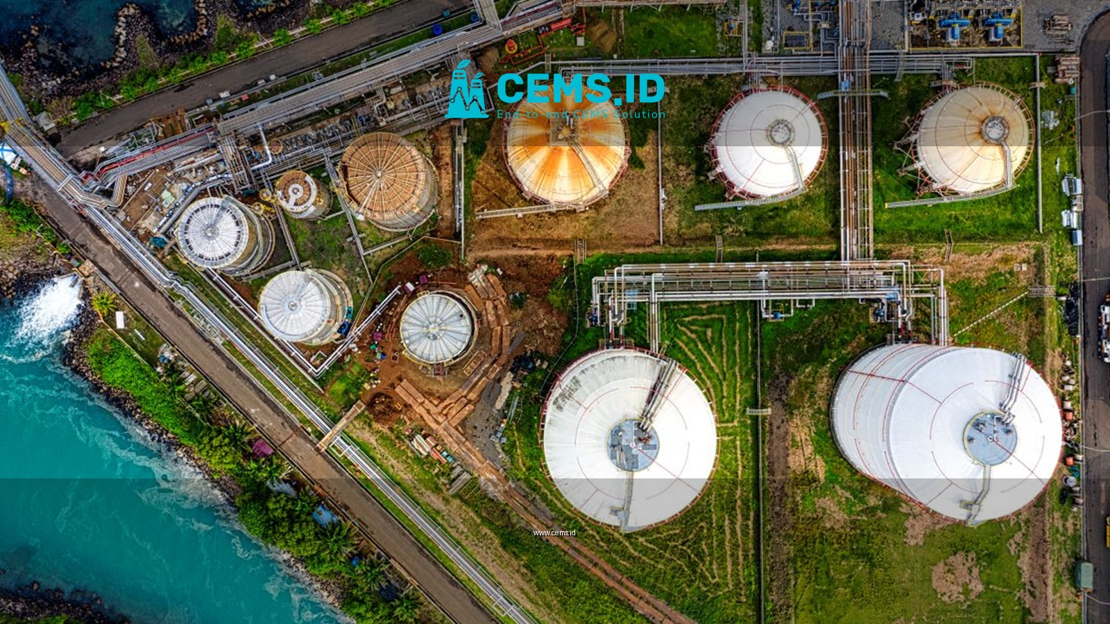 Aerial view of an industrial complex near a river in Banten, Indonesia, showcasing storage tanks.
