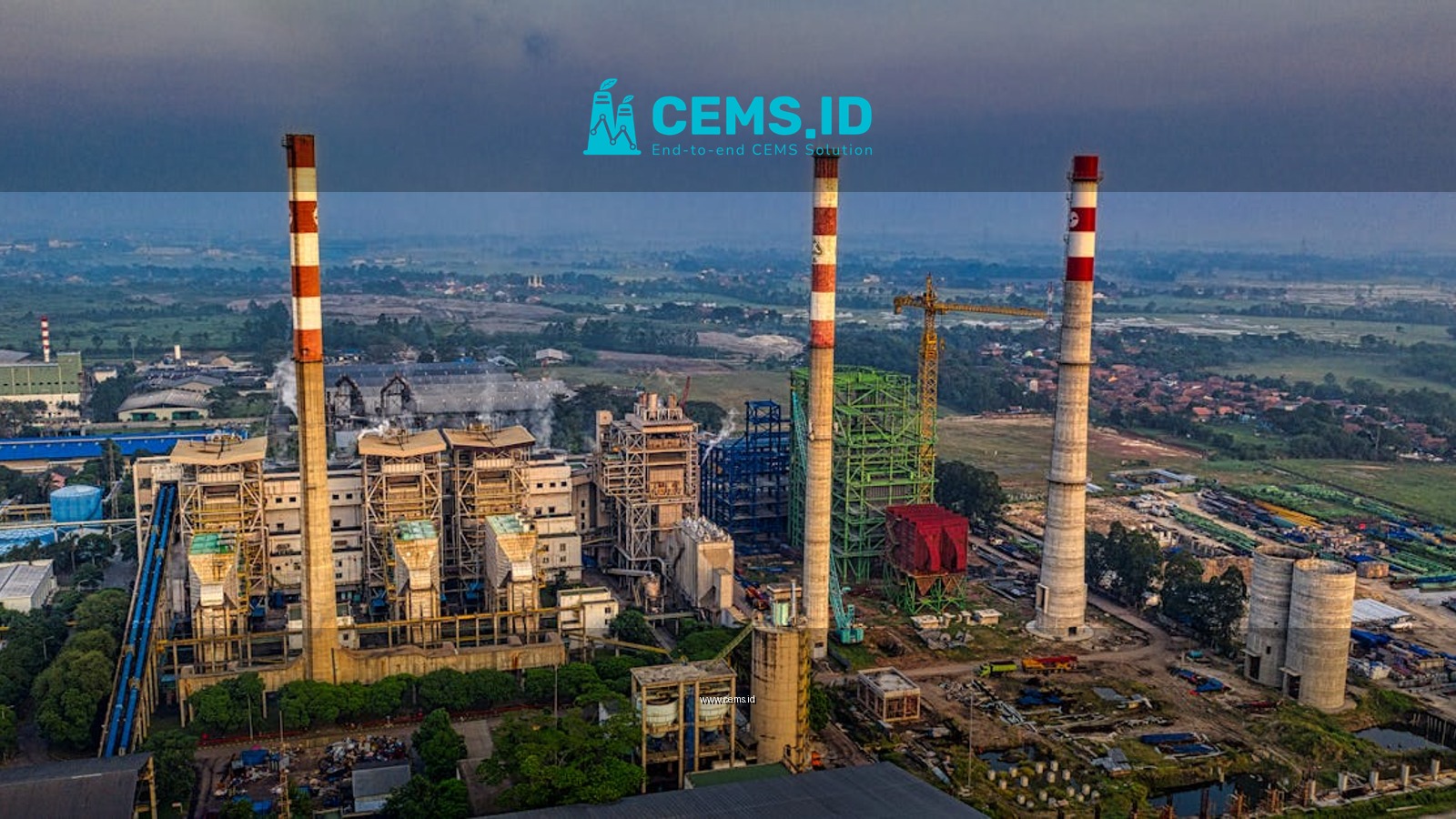 Aerial view of an industrial plant with smokestacks in Serang, Banten, Indonesia during daylight.