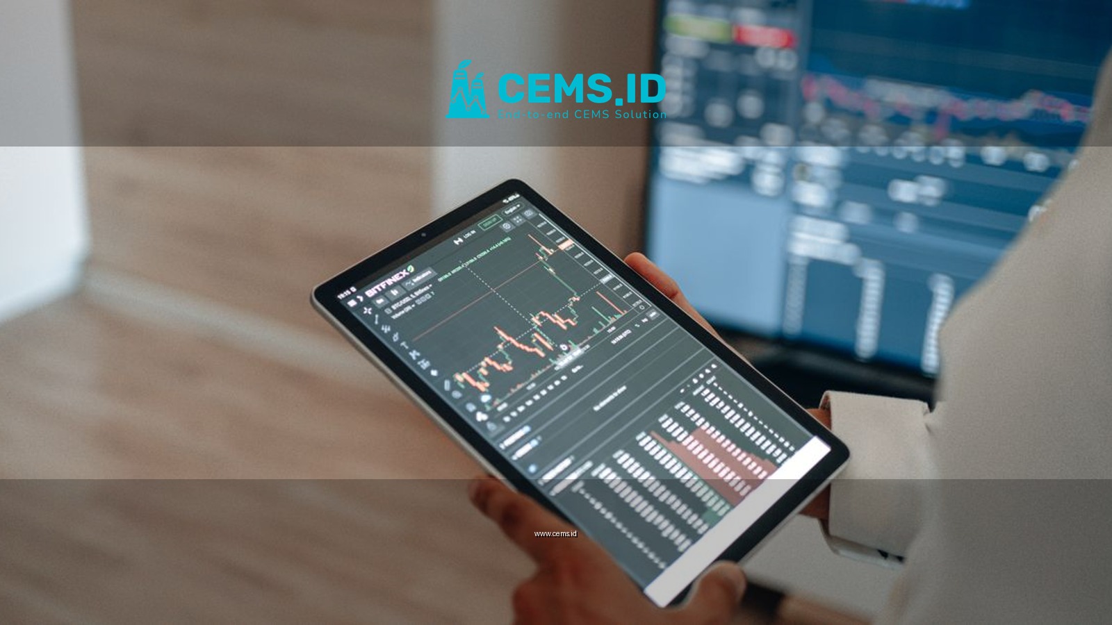 A person uses a tablet to monitor stock market trends and real-time trading graphs.