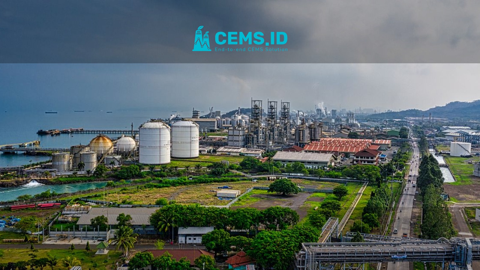 Aerial view of a coastal industrial area in Banten, Indonesia, with factories and overcast skies.
