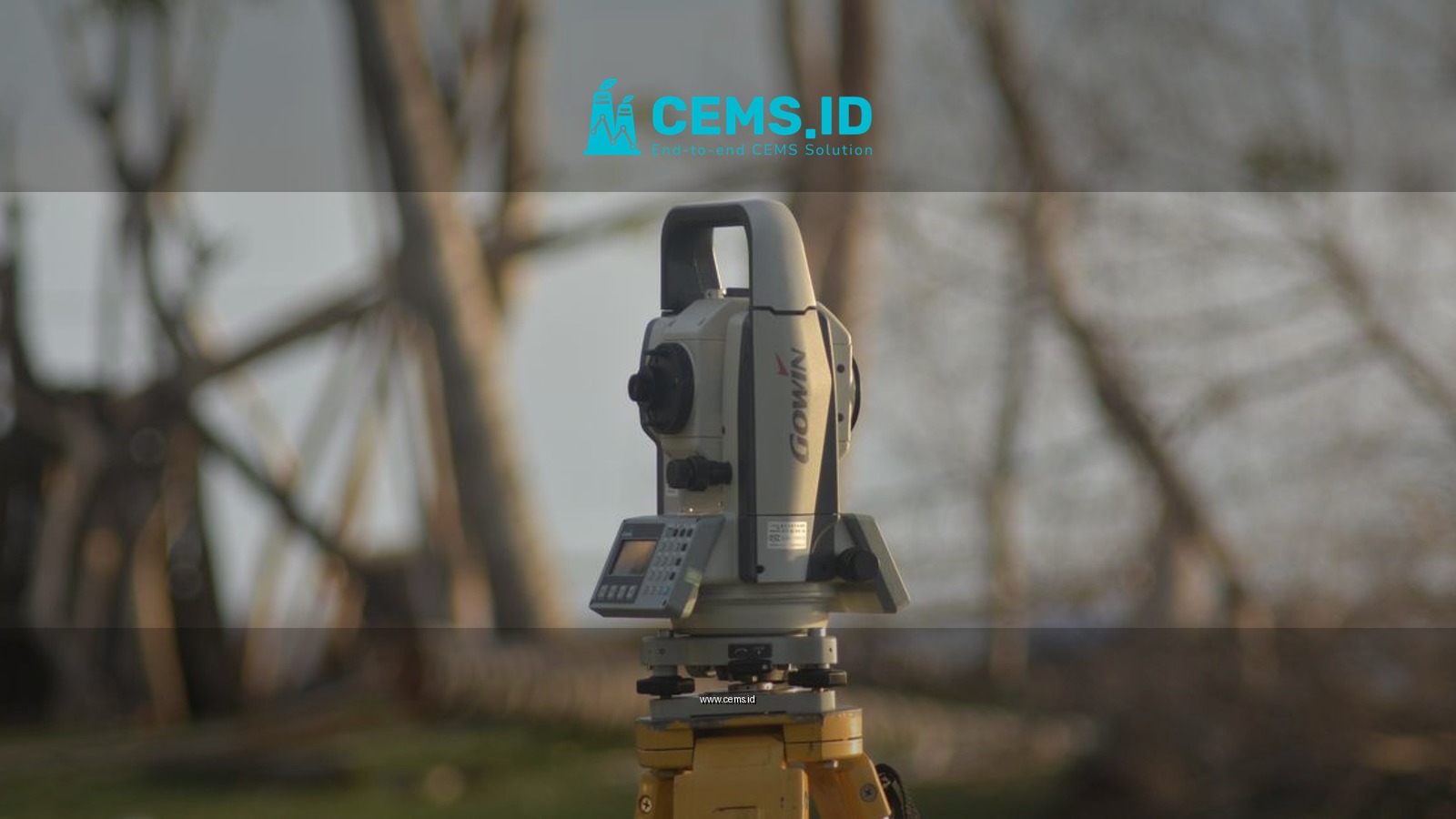 A precise total station used for geodetic surveying at a construction site with a natural background.