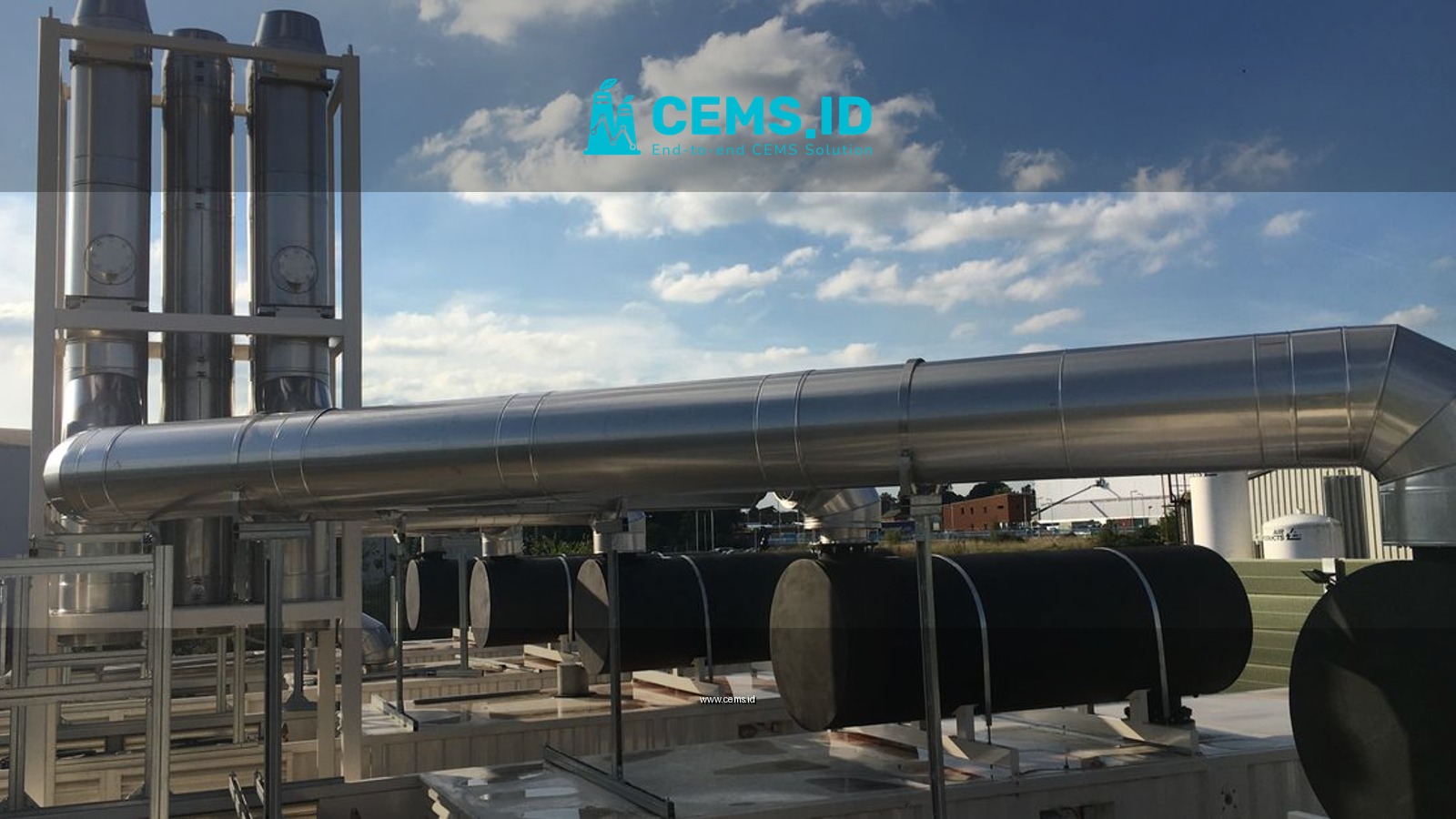 Modern industrial chimneys and support mast with flues against a clear blue sky, showcasing advanced infrastructure.