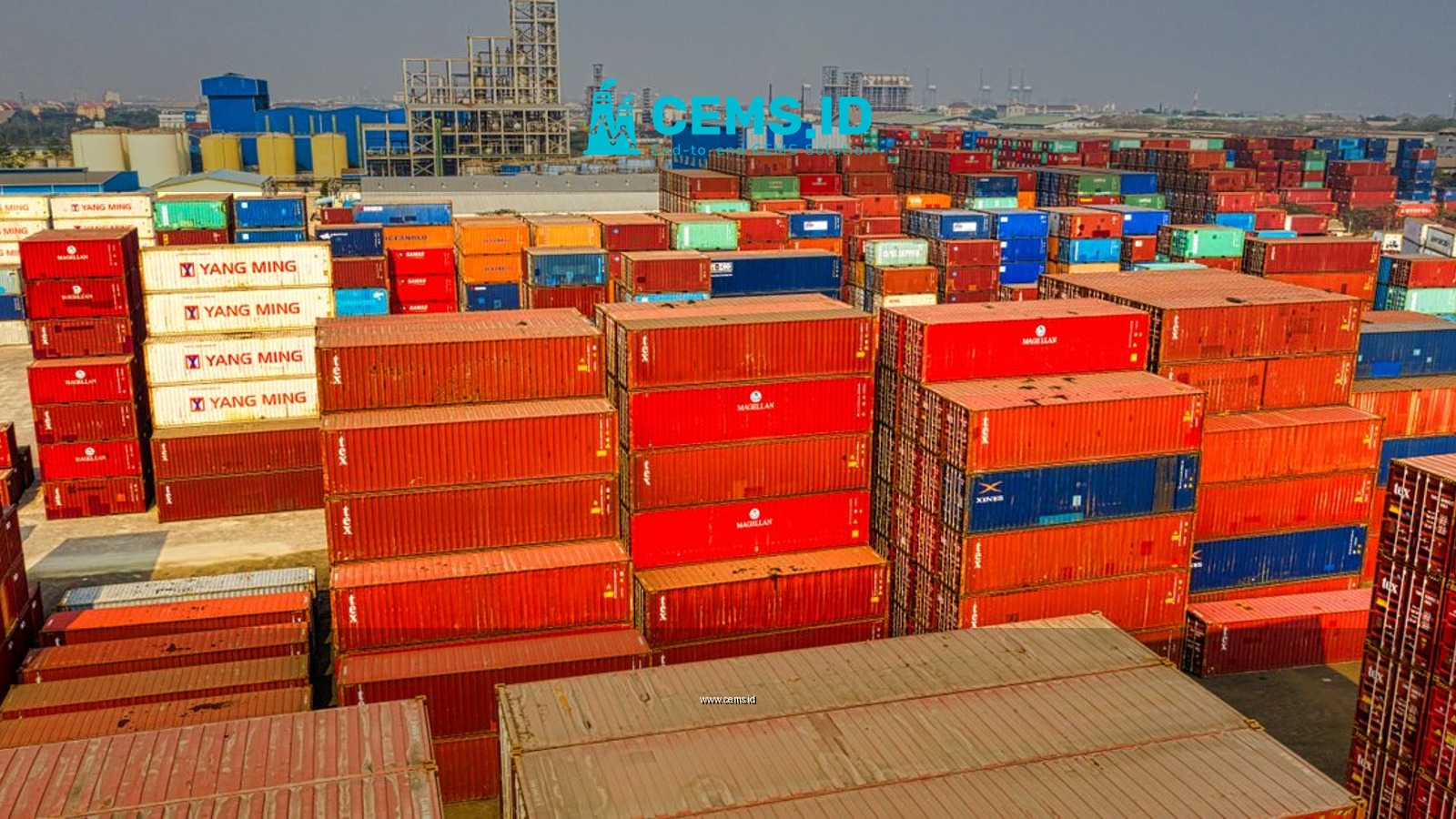 Drone shot showcasing stacked colorful cargo containers at Jakarta port.