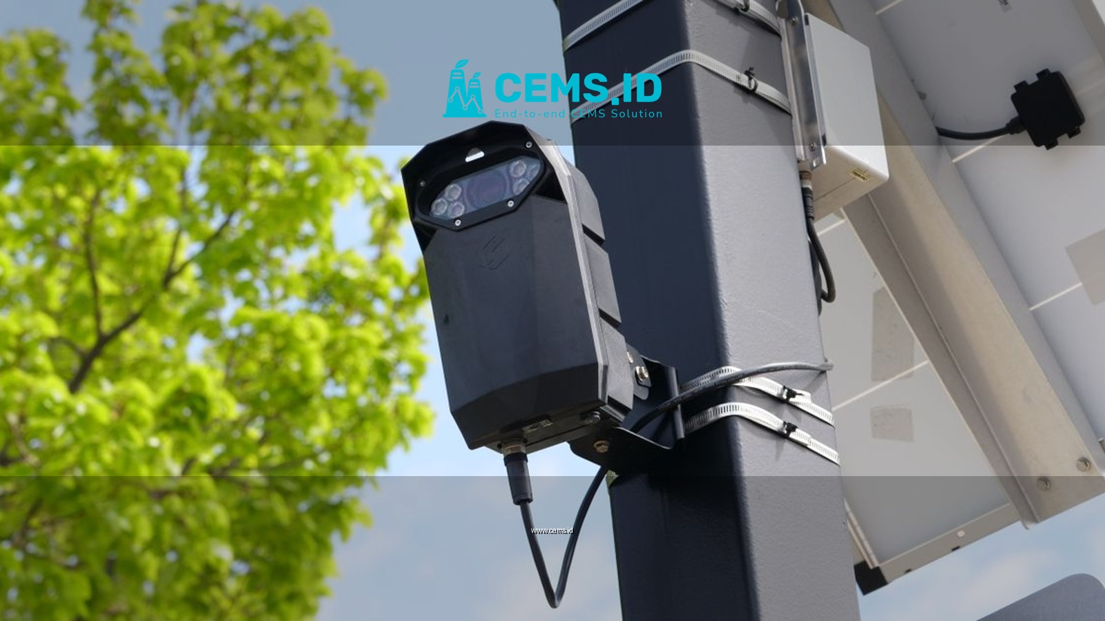 A modern surveillance camera powered by solar energy mounted on a street pole.