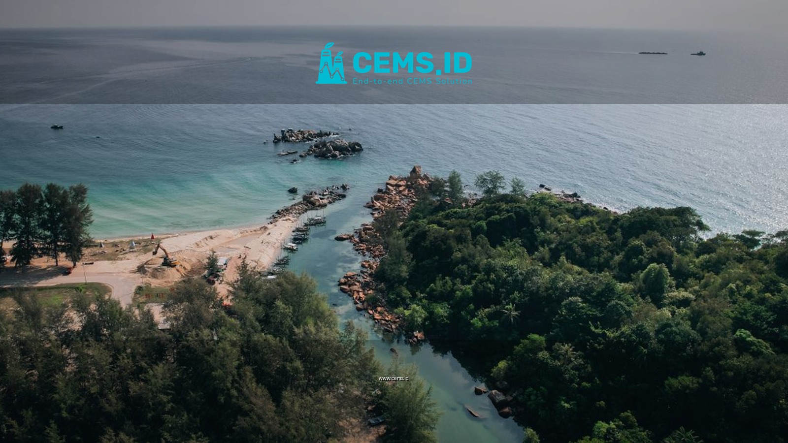 Explore the serene landscape of Tanjung Balau's coastline captured from above, showcasing lush greenery and calming waters.