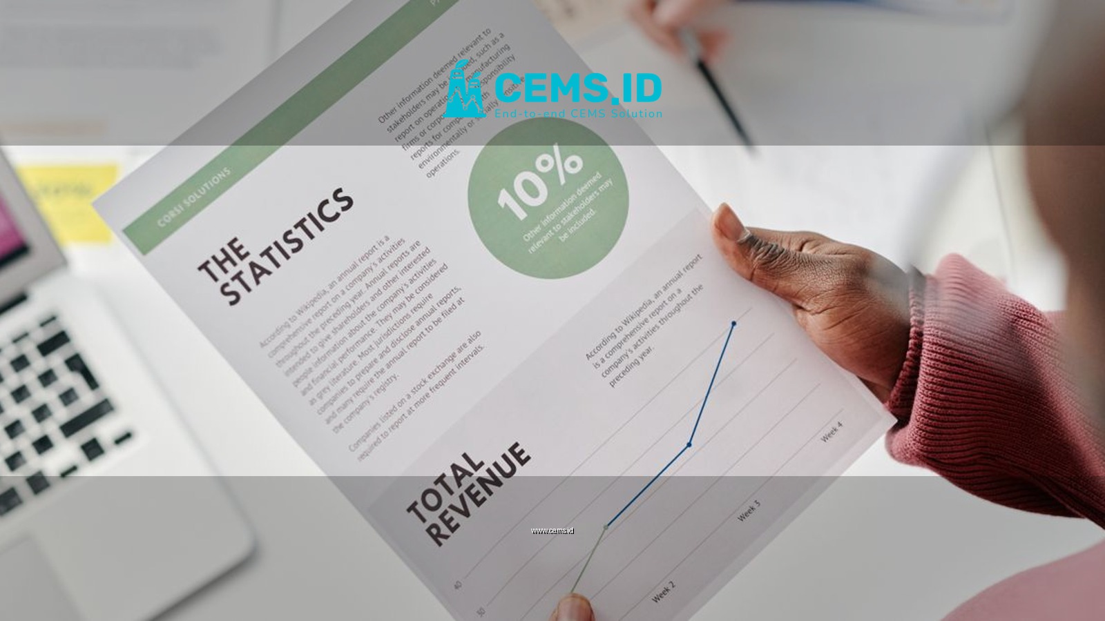 Hands holding a statistical report during a business meeting. Includes revenue graphs and analysis.