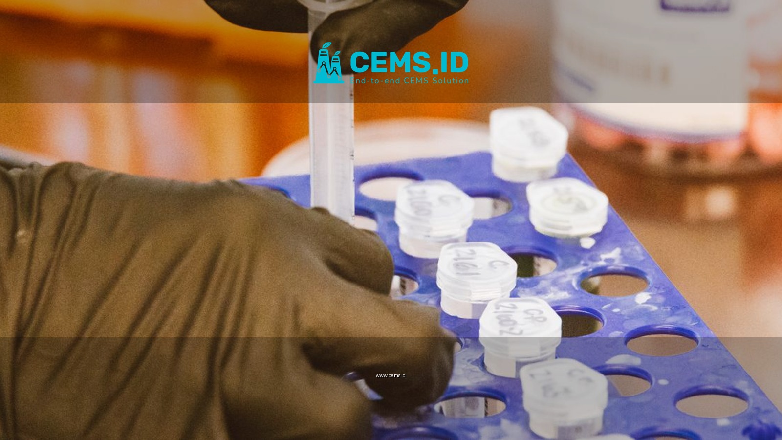 Close-up of gloved hands using syringe for precise work in a lab setting.