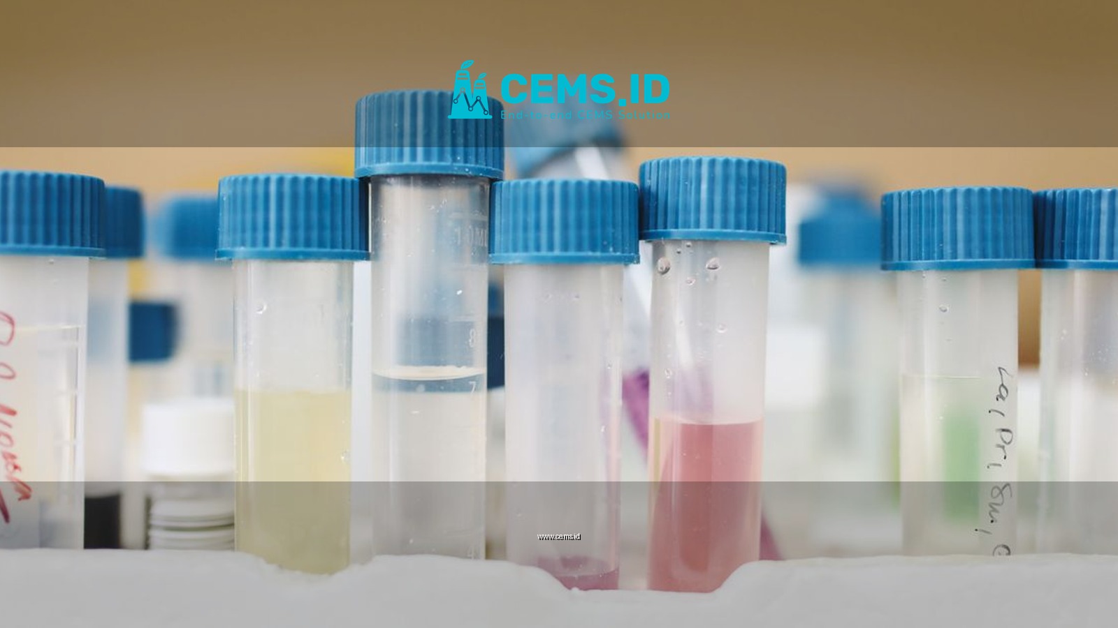 Close-up of colorful test tubes with blue caps in a laboratory setting.
