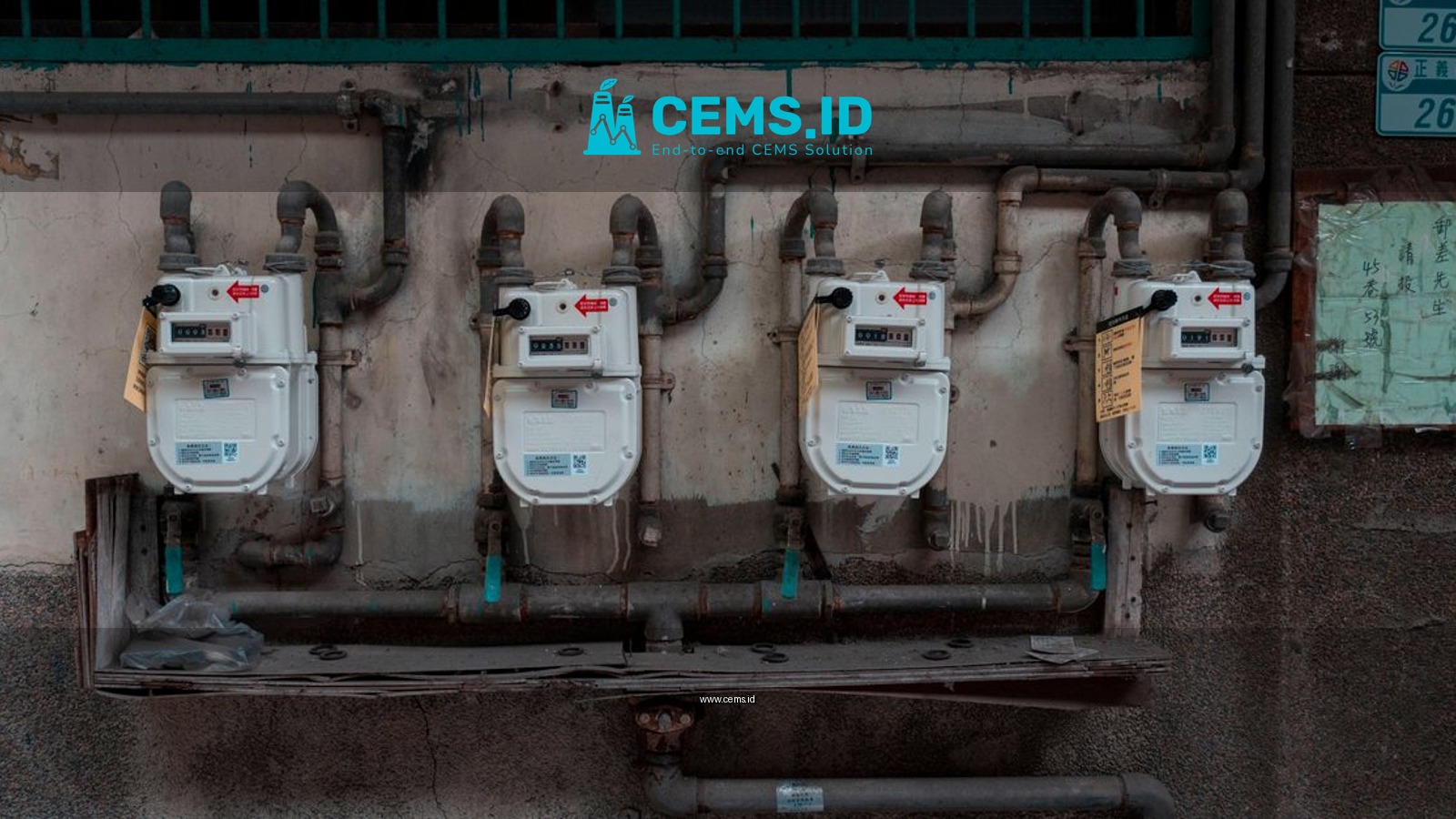 Four gas meters mounted on an exterior wall, showcasing urban utility infrastructure.