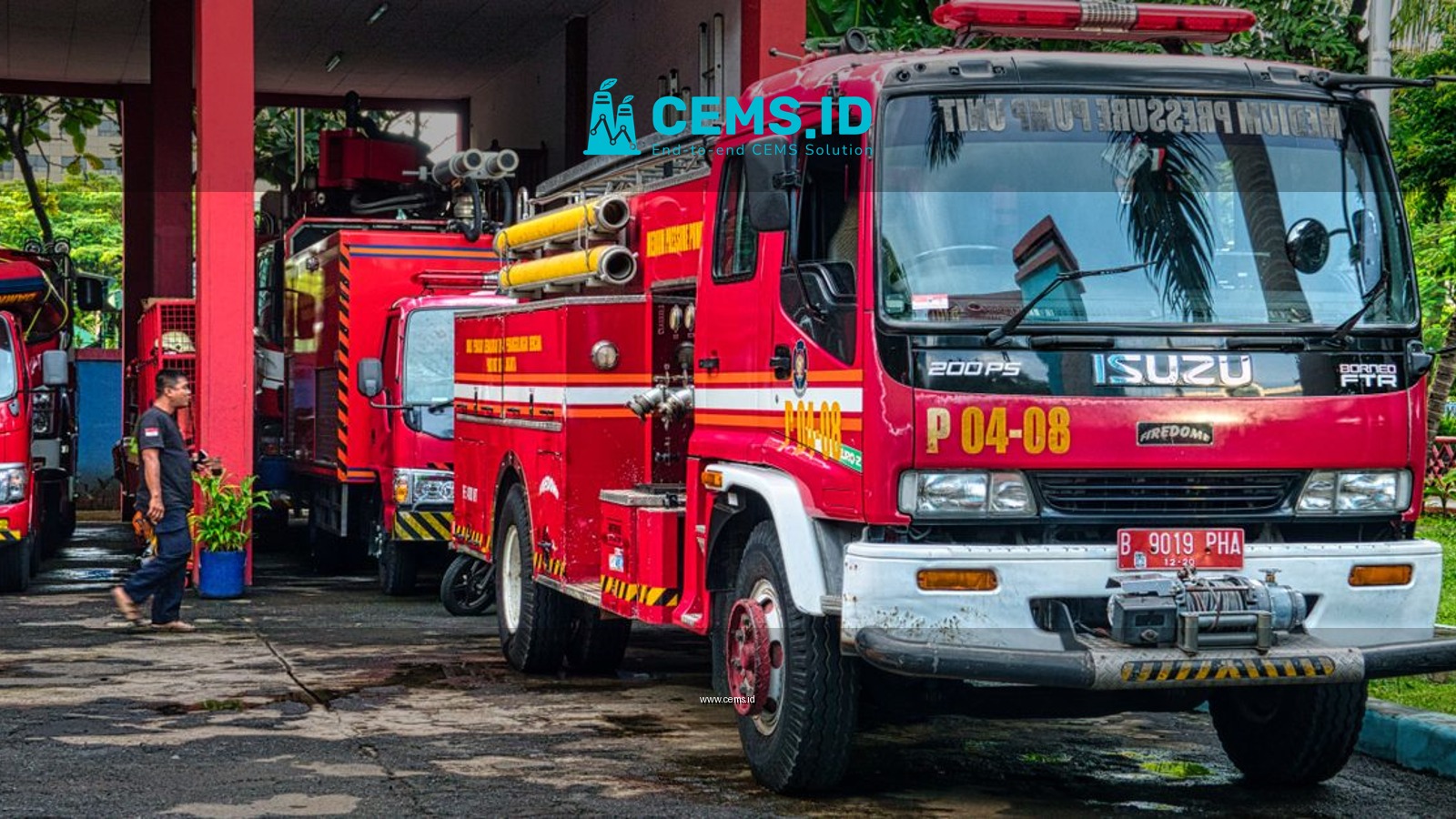 Fire trucks parked at an outdoor fire station in Jakarta, Indonesia during the day.