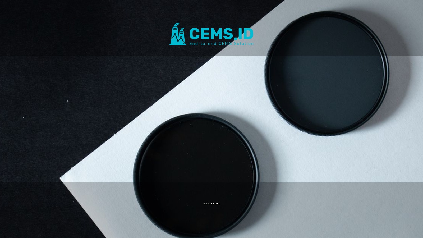 A modern minimalist photo of two black circular filters on contrasting paper for design and technology concepts.