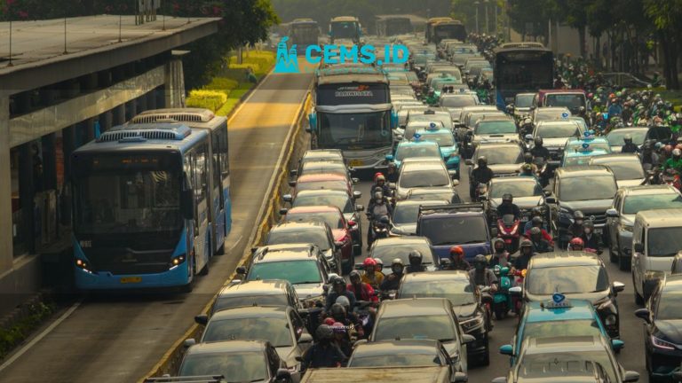 Dense traffic with buses, cars, and motorbikes in a busy urban street during daytime.