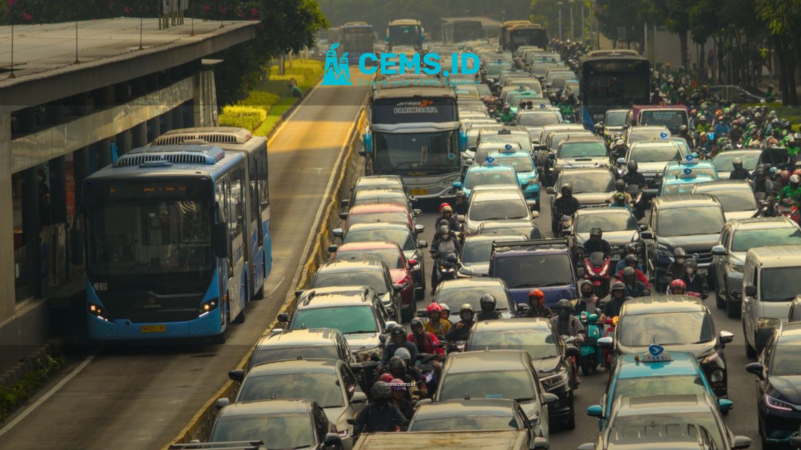 Dense traffic with buses, cars, and motorbikes in a busy urban street during daytime.