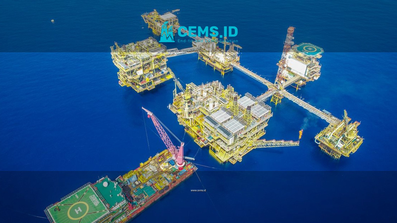 Aerial shot of an offshore oil platform complex in the ocean, showcasing industrial infrastructure.