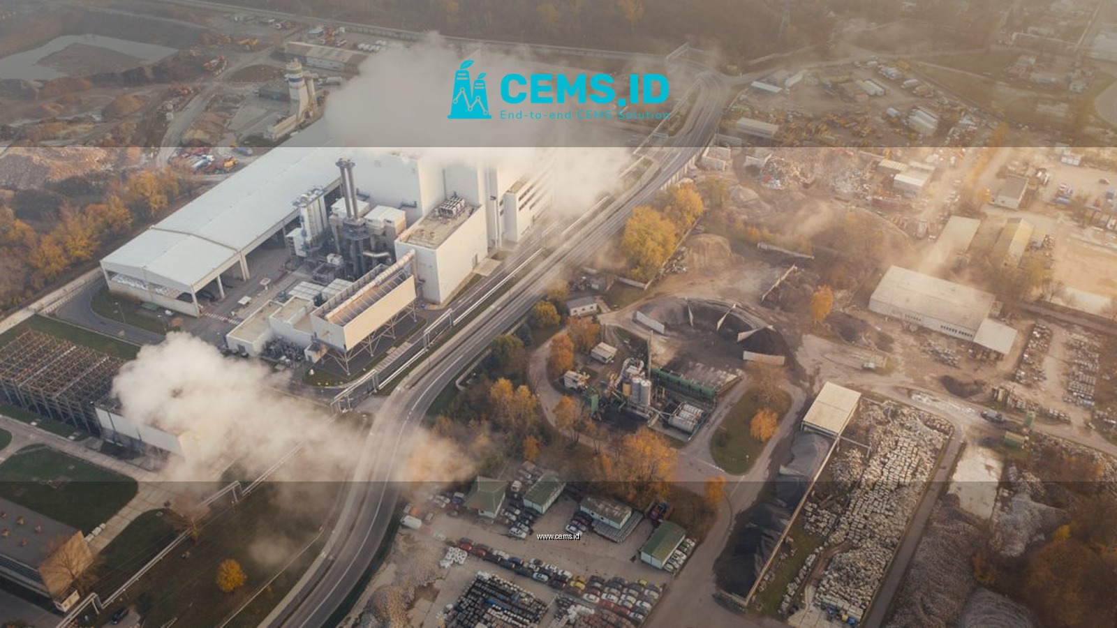 Aerial view showcasing an industrial complex in Poznań, Poland, emitting smoke and steam.