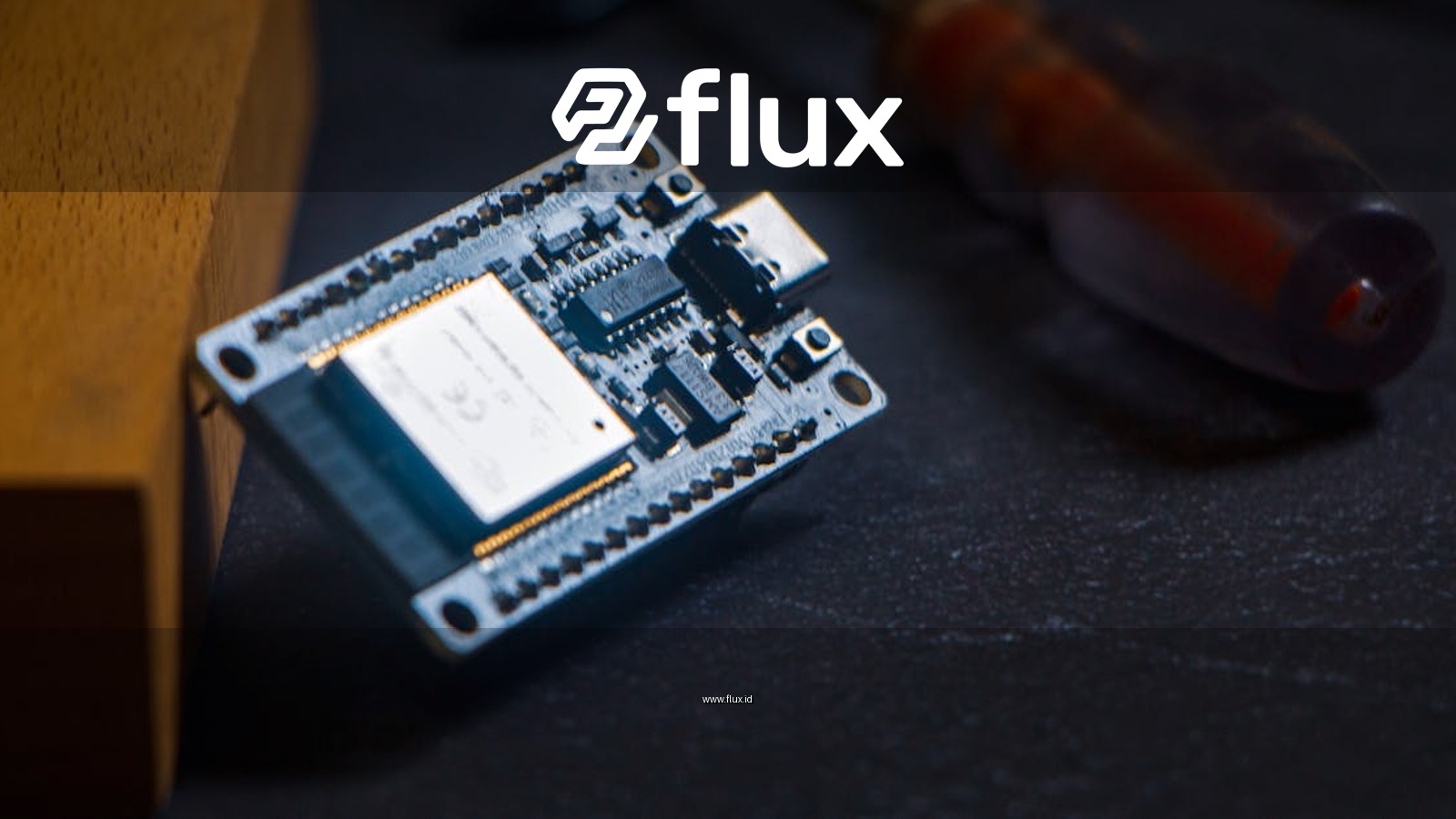 Microcontroller chip with screwdriver on dark surface, ideal for tech and innovation themes.