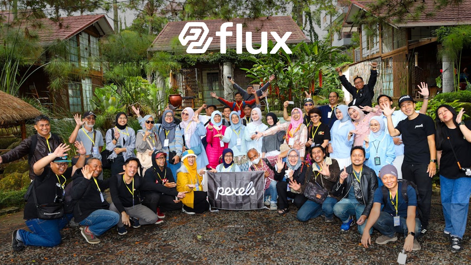 A large group of diverse people pose together for a fun photo outdoors in Jawa Barat, Indonesia.