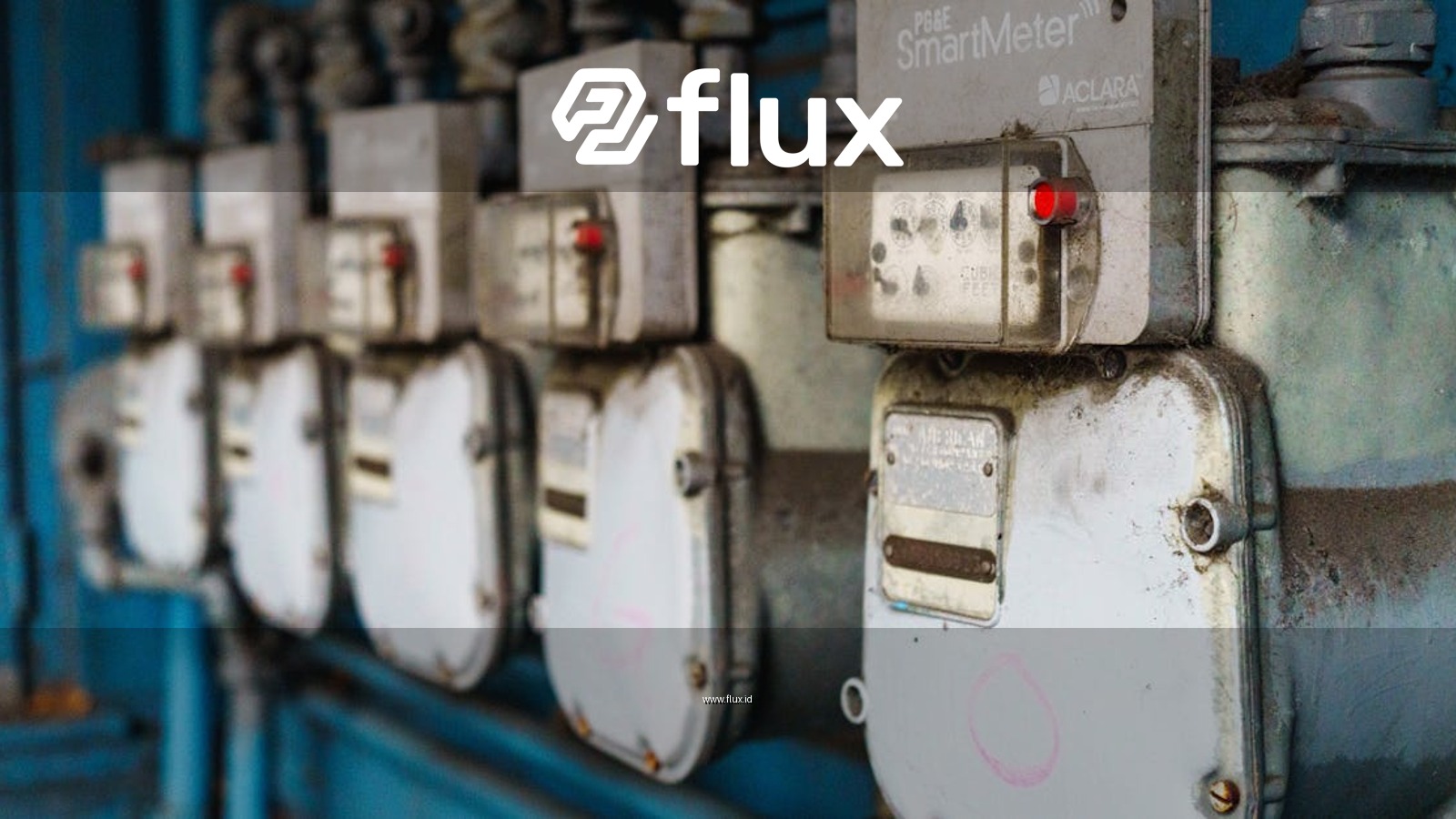 Multiple smart utility meters lined up on a blue industrial wall.