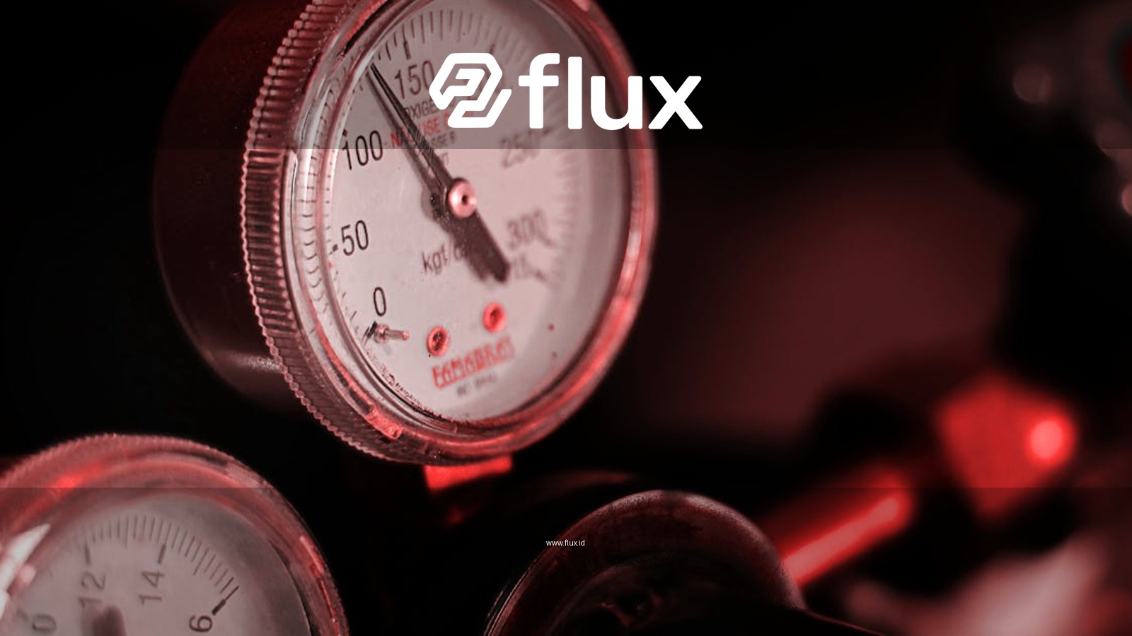 Detailed view of pressure gauges with red lighting in an industrial setting.