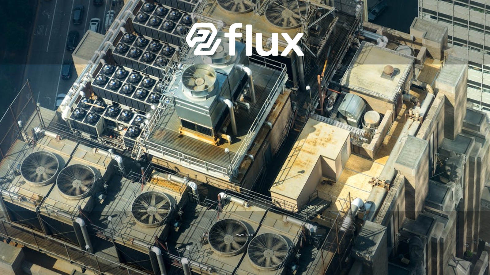 High-angle shot of HVAC units on a city building's rooftop, showcasing industrial infrastructure.