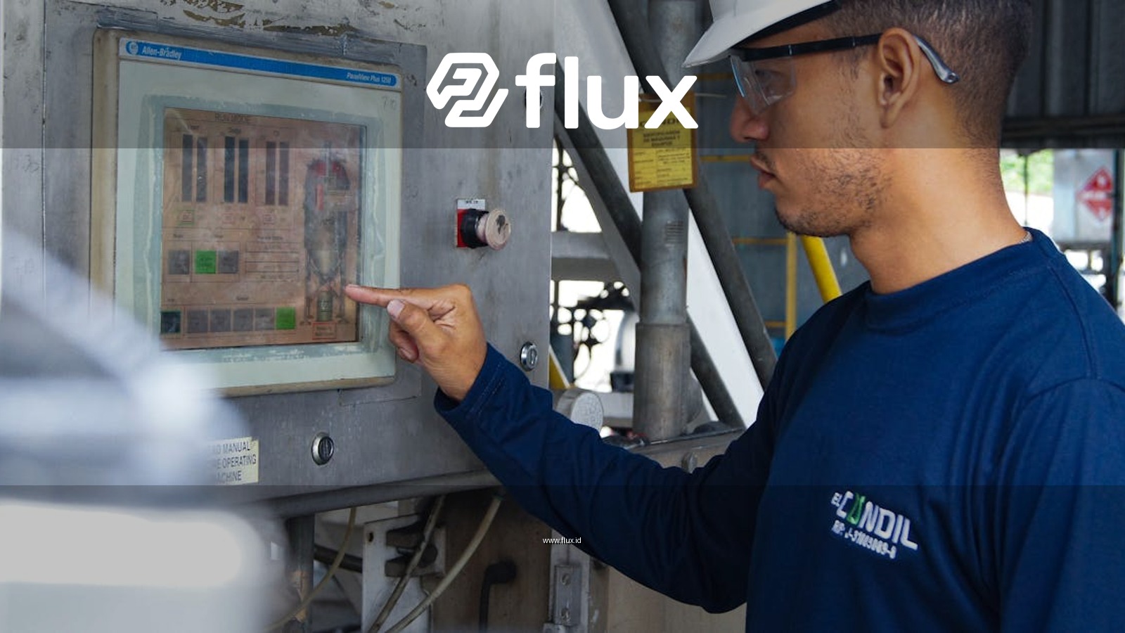 Engineer using control panel at industrial facility, ensuring operational efficiency.